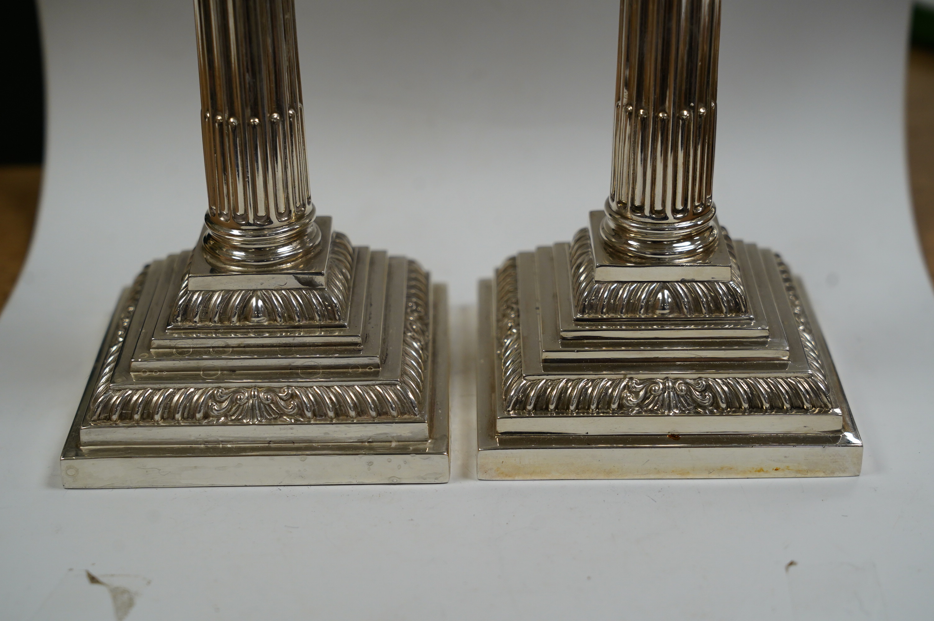 A pair of modern silver Corinthian column dwarf candlesticks, by James Dixon & Sons Ltd, Sheffield, 1991, height 16.4cm, weighted. Condition - fair